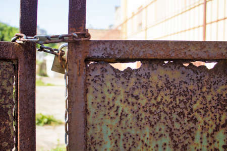 evocative image of part of rusty gate with chain and lockのeditorial素材