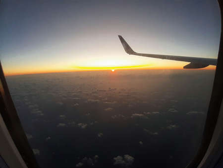 2020.02.20 Palermo Punta Raisi, Ryanair plane wing on the clouds with the sun rising on the horizonのeditorial素材