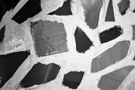 evocative black and white image of mosaic texture with various shapes