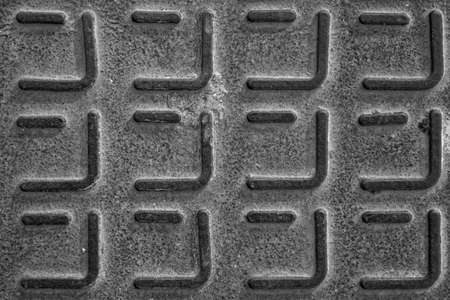 evocative black and white image of texture of intertwined mesh iron grateの写真素材