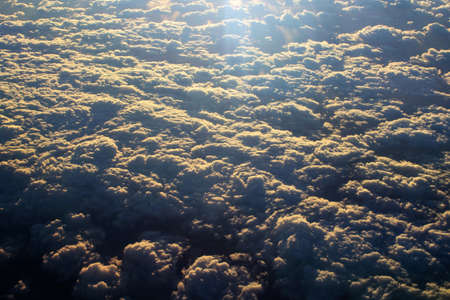 spectacular sunset seen from an airplane with clouds in the foreground and in the distance