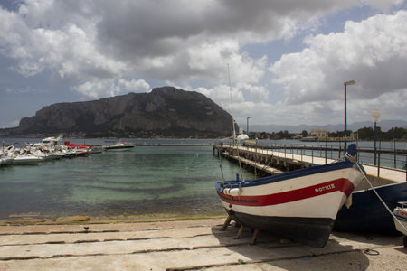 evocative image of fishing boats moored in the harbor in a small fishing village in Sicily, Italyの写真素材