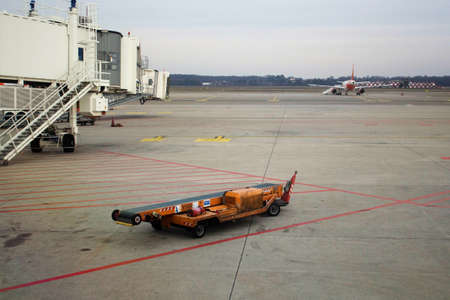 20.12.27 Milan Malpensa Airport, external passenger boarding area, transport trolley for loading...