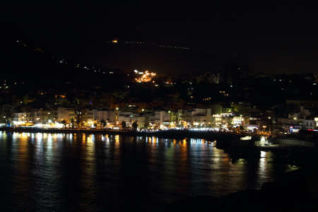 evocative night image of a seaside town in Sicilyの写真素材