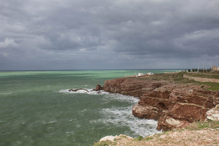 evocative image of sea coast with promontory on the background in Sicily, Italyの写真素材