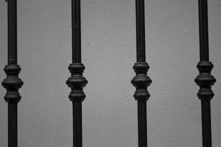 evocative black and white image of texture of rods du a wrought iron gratingの写真素材