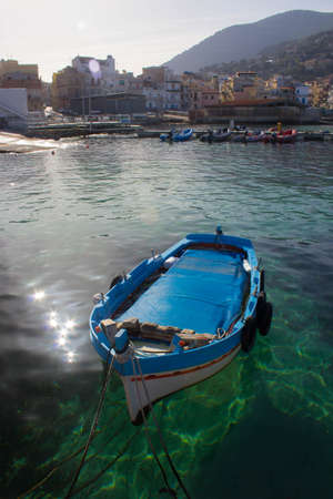 evocative image of fishing boats moored in the harbor in a small fishing village in Sicily, Italyの写真素材