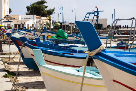 evocative close-up image of the bow of a boat boats moored in the harbor in a small fishing village in Sicily, Italyの写真素材