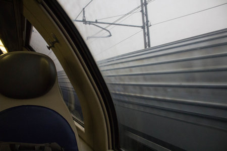 evocative image of the passage of a train seen from the window of another on a bad dayの写真素材