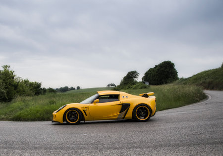 ITALY THOUSAND MILES 2015 PESARO, ITALY - MAY 15: lotus elise yellow on an old racing car in rally Mille Miglia 2015, the famous historical italian race (1927-1957) on May 2015のeditorial素材