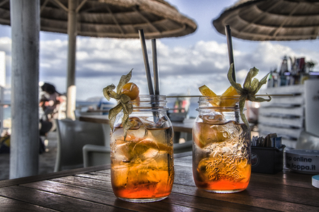 cocktails on a table at an outdoor restaurant on the beachの写真素材