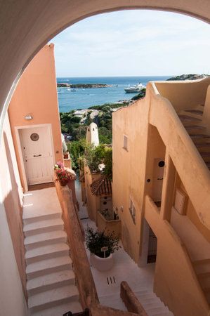 PORTO CERVO ITALY- July 2017 - Coastline promenade with pine trees and turquoise clear water at Porto Cervo town. Porto Cervo is the capital of Sardinia Italy.のeditorial素材