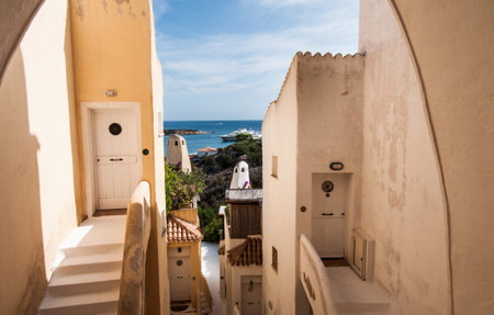 PORTO CERVO ITALY- July 2017 - Coastline promenade with pine trees and turquoise clear water at Porto Cervo town. Porto Cervo is the capital of Costa Smeralda Sardinia Italy.のeditorial素材