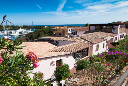 PORTO CERVO ITALY- July 2017 - Coastline promenade with pine trees and turquoise clear water at Porto Cervo town. Porto Cervo is the capital of Costa Smeralda Sardinia Italy.のeditorial素材