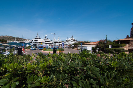 PORTO CERVO ITALY- AUGUST 2017 - Coastline promenade with pine trees and turquoise clear water at Porto Cervo town. Porto Cervo is the capital of Costa Smeralda Sardinia Italyのeditorial素材