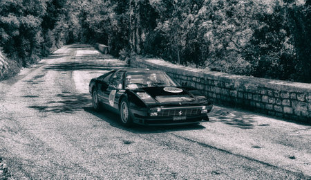 GOLA DEL FURLO, ITALY - FERRARI 308 GTS 1984 on an old racing car in rally Mille Miglia 2017 the famous Italian Historical Race (1927-1957) on May 19 2017のeditorial素材