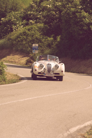 PESARO COLLE SAN BARTOLO , ITALY - MAY 17 - 2018 : JAGUAR XK 140 OTS 1955 on an old racing car in rally Mille Miglia 2018 the famous italian historical race (1927-1957)のeditorial素材
