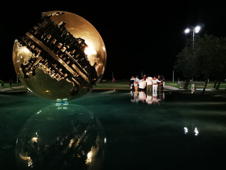 PESARO, ITALY - 10 AUGUST 2021: ball sculpture of pomodoro in the eveningのeditorial素材