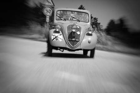 URBINO, ITALY - JUN 16 - 2022: FIAT 500 B TOPOLINO 1948 on an old racing car in rally Mille Miglia 2022 the famous italian historical race (1927-1957のeditorial素材