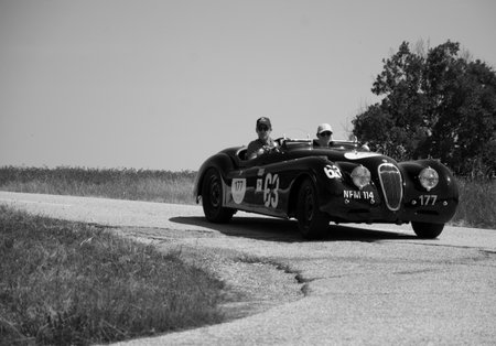 URBINO - ITALY - JUN 16 - 2022: JAGUAR XK120 OTS ROADSTER 1950 on an old racing car in rally Mille Miglia 2022 the famous italian historical race (1927-1957のeditorial素材
