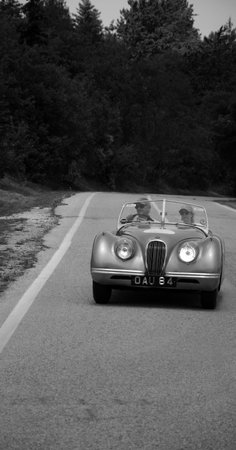 URBINO - ITALY - JUN 16 - 2022: jaguar on an old racing car in rally Mille Miglia 2022 the famous italian historical race (1927-1957のeditorial素材