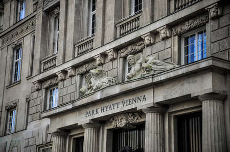 Wien, Austria - Park Hyatt, sculptures on the building. Details of the two men on the entranceのeditorial素材