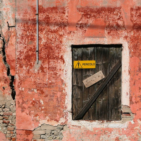 Old red decadent wall with a closed window の写真素材