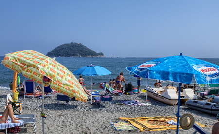 Albenga, Liguria, Italy. July 2018. The Gallinara island is a landmark on the beaches around Albenga. Its unmistakable shape is reminiscent of a large turtle. Swimmers can enjoy the view.のeditorial素材