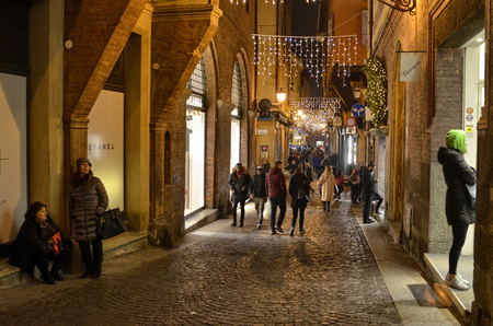 Bologna, Emilia Romagna, Italy. December 2018. Entering the historical center, among the small secondary roads, at dusk there are a thousand yellow lights for the Christmas holidays. Very nice.のeditorial素材