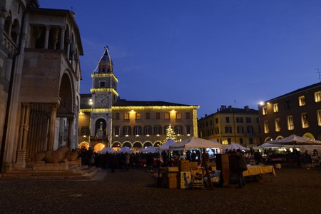 Modena, Emilia Romagna, Italy. December 2018. Piazza Maggiore is the center of the city. The clock tower and the cathedral are characteristic elements of the square. The dark lights up the Christmas lights.のeditorial素材