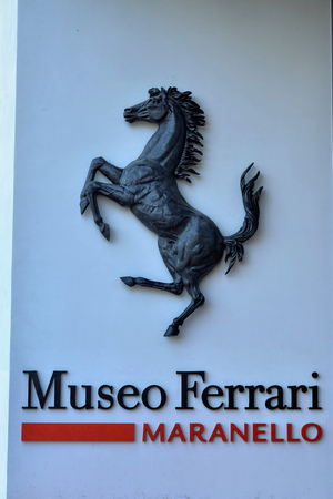 Maranello, Italy, December 2018. Entrance to the Ferrari museum, The black prancing horse leaves no doubt: we are in the home of engines. People stop for a souvenir photo.のeditorial素材