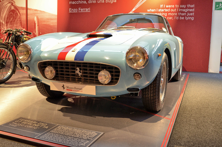 Maranello, Emilia Romagna, Italy. December 2018. At the Ferrari museum the exhibition hall with models of debut. The 250 GT berlinetta and the 166 MM. Enzo Ferrari's memorable statements on the walls.のeditorial素材
