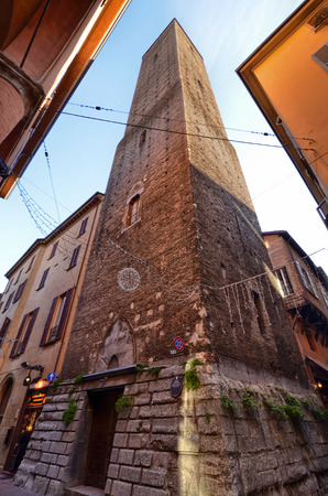 Bologna, Emilia Romagna, Italy. December 2018. The Tower of Azzoguidi also called Altabella, 61 meters high. It is one of the 20 towers still existing in the city. People stroll.のeditorial素材