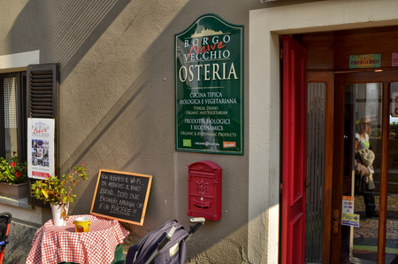 Neive, Piedmont, Italy. October 2018. There are several restaurants offering typical products of the area. They attract tourists with menus and bottles of wine on the street.のeditorial素材