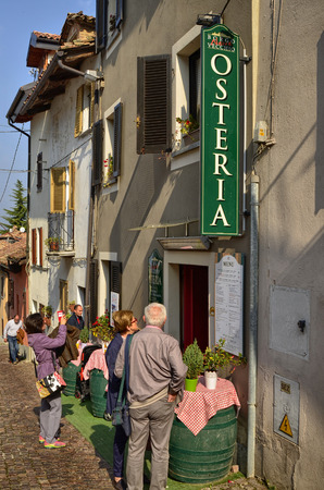 Neive, Piedmont, Italy. October 2018. There are several restaurants offering typical products of the area. They attract tourists with menus and bottles of wine on the street.のeditorial素材