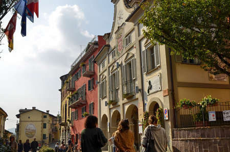 Neive, Piedmont, Italy. October 2018. In the square of the historic center the town hall draws attention with its clock and the banner with the common inscription of Neive.のeditorial素材