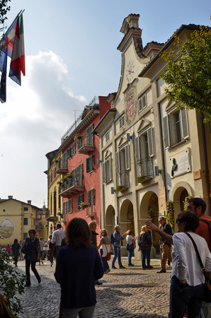 Neive, Piedmont, Italy. October 2018. In the square of the historic center the town hall draws attention with its clock and the banner with the common inscription of Neive.のeditorial素材