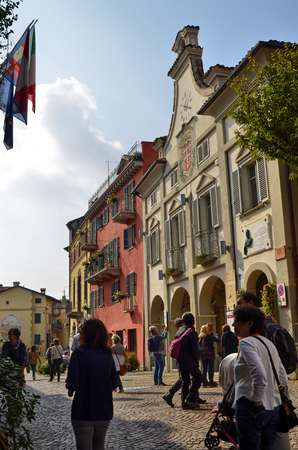 Neive, Piedmont, Italy. October 2018. In the square of the historic center the town hall draws attention with its clock and the banner with the common inscription of Neive.のeditorial素材