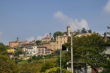 Neive, Italy. October 2018. Going up towards the village the view is enchanting: on the top of the hill the inhabited center, the clock tower stands out, at the foot the magnificent vineyards.のeditorial素材