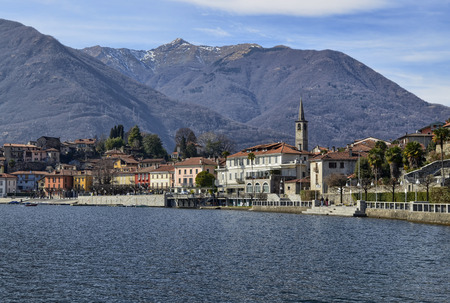 Mergozzo, Piedmont, Italy. March 2019. View of the village overlooking the calm waters of the lake. The facades with their warm and bright colors stand out.のeditorial素材