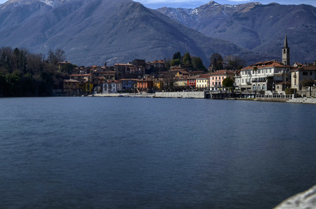 Mergozzo, Piedmont, Italy. March 2019. View of the village overlooking the calm waters of the lake. The facades with their warm and bright colors stand out.のeditorial素材