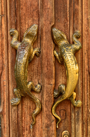 Turin, Piemonte, Italy. October 2018. The house of victory or home of the dragons, is one of the examples of the Neo-Gothic style civil residence of the city. Detail of the door handles.のeditorial素材