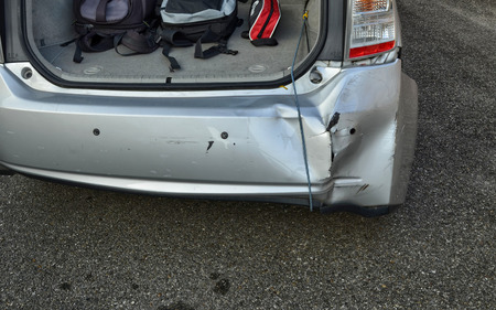 Turin, Piemonte, Italy. October 2018. A Toyota Prius in metallic gray was damaged. The rear bumper is visibly damaged on the right, an elastic rope keeps it raised.のeditorial素材