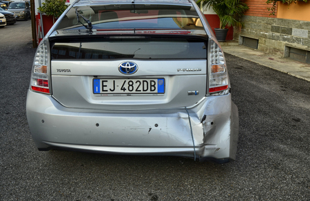 Turin, Piemonte, Italy. October 2018. A Toyota Prius in metallic gray was damaged. The rear bumper is visibly damaged on the right, an elastic rope keeps it raised.のeditorial素材