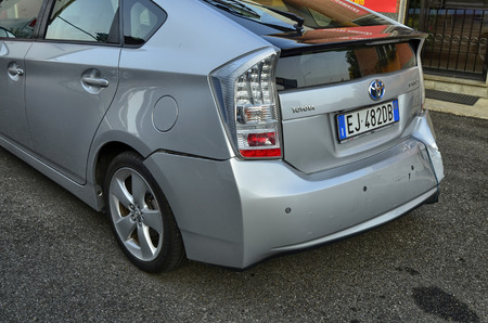 Turin, Piemonte, Italy. October 2018. A Toyota Prius in metallic gray was damaged. The rear bumper is visibly damaged on the right, an elastic rope keeps it raised.のeditorial素材