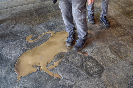 Turin, Piedmont, Italy. March 2019. Piazza San Carlo. Under the arcades, in front of one of the most famous cafÃ©s, is the symbol of Turin: the bull. The custom is to beat the genitals.のeditorial素材