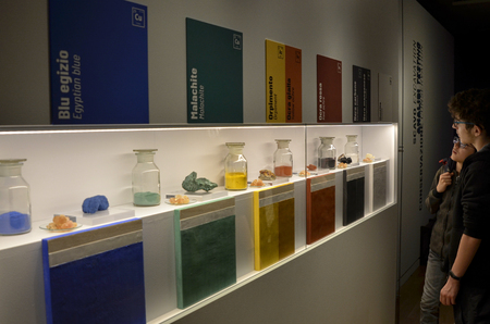 Turin, Piemonte, Italy. March 2019. At the Egyptian museum, display of glass vases containing oxide powders used as colors by the ancient Egyptian people. Two young visitors observe curiously.のeditorial素材