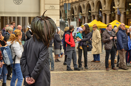 Turin, Piedmont, Italy. April 2019. In Piazza San Carlo a performance by the military corps of the Bersaglieri. A veteran observes the show wearing the typical hat of the corp with long feathers.のeditorial素材