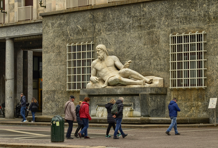 Turin, Piedmont, Italy. April 2018. Tourists cross CNL square, characterized by two fountains that embody the two rivers of the city. That of man is the fountain of the river Po.のeditorial素材