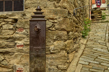 Fenestrelle, Piedmont, Italy.April 2019.The mountain village of Fondufaux, a hamlet of Fenestrelle. A fountain from the fascist period: the lictory beam, symbol of the era, is clearly distinguishable.のeditorial素材